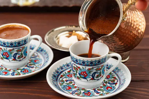 Traditional turkish coffee in oriental dishware close up photo