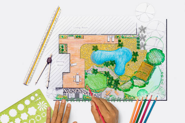 istock Landscape architect student designing backyard garden and pool plan for villa. 1324622855