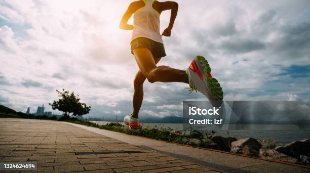 Fitness Woman Running Training For Marathon On Sunny Coast Trail Stock Photo - Download Image Now