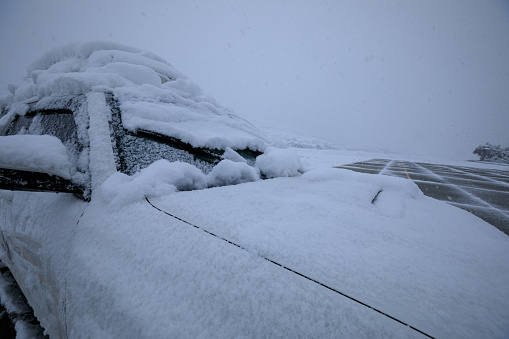 Car tank close-up. Car under snow. Winter weather. Climate. Storm. Transportation