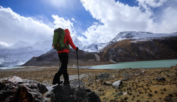 istock Woman backpacker hiking in winter high altitude mountains 1324628209