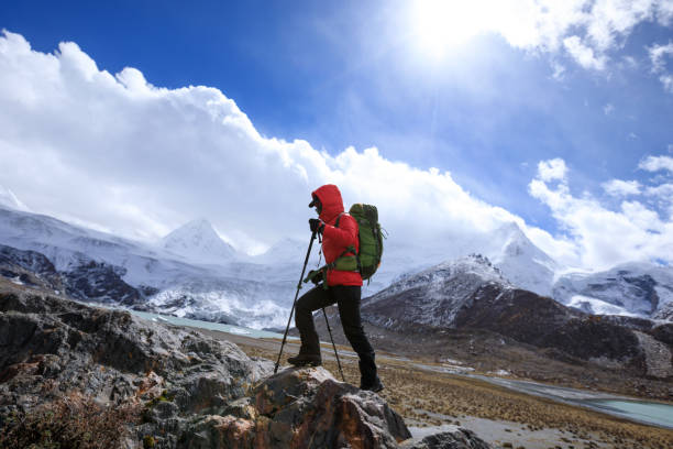 istock Woman backpacker hiking in winter high altitude mountains 1324628232