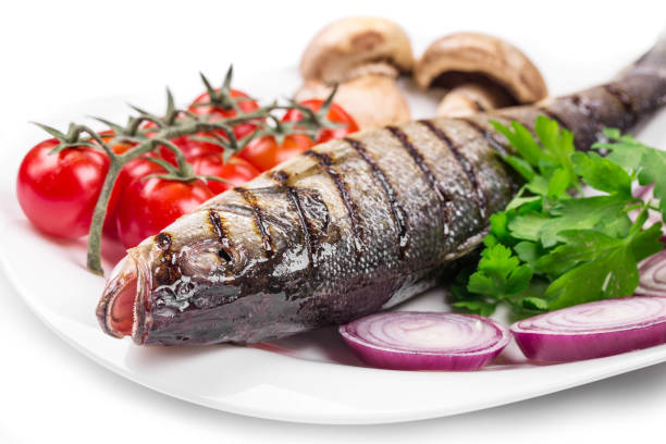 istock Grilled seabass on a plate with tomatoes. 1324631233