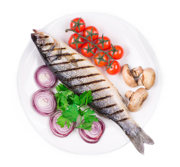 istock Grilled seabass with cherry tomatoes on a plate. 1324631391