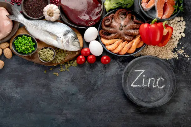 Food high in zinc on dark background. Healthy eating concept. Top view, flat lay, copy space