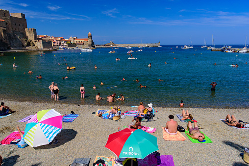 People having fun on the beach in summer in Collioure, France