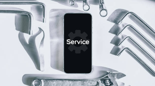 istock Repair phone. Technician workplace with phone and special repairing tools. Disassembling, diagnostic and repairman smartphone. 1324635165
