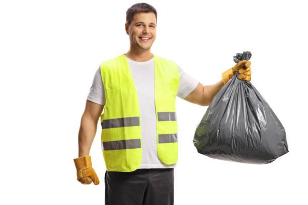 istock Man in a vest holding a black plastic bin bag 1324640029