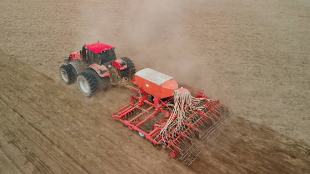 istock Tractor pulls a combined crop unit across the prairie 1324640123