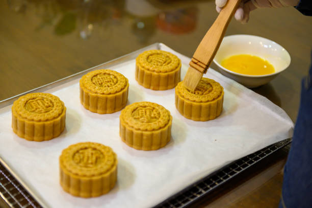 istock Moon cake baker brushing egg liquid on top prepare for bake 1324648786