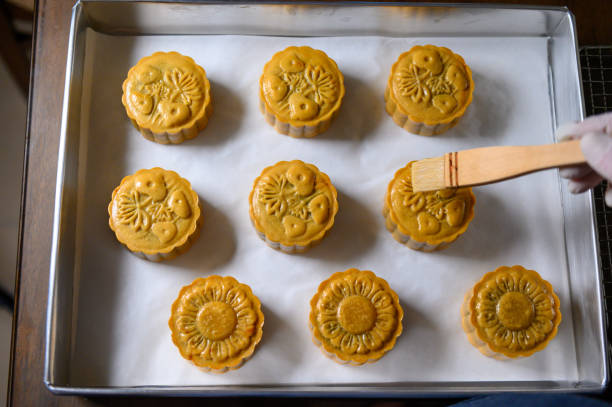 istock Moon cake baker brushing egg liquid on top prepare for bake 1324648795
