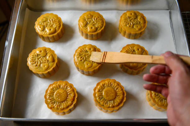 istock Moon cake baker brushing egg liquid on top prepare for bake 1324648796