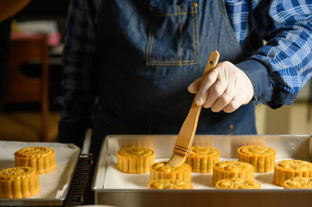 istock Moon cake baker brushing egg liquid on top prepare for bake 1324648818