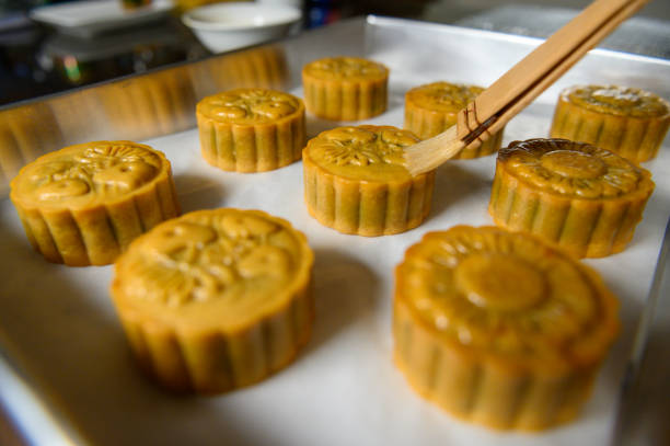 istock Moon cake baker brushing egg liquid on top prepare for bake 1324648834