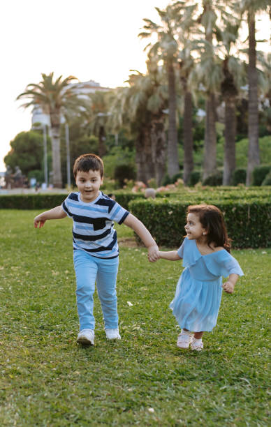 istock Brother and sister playing in park 1324649874