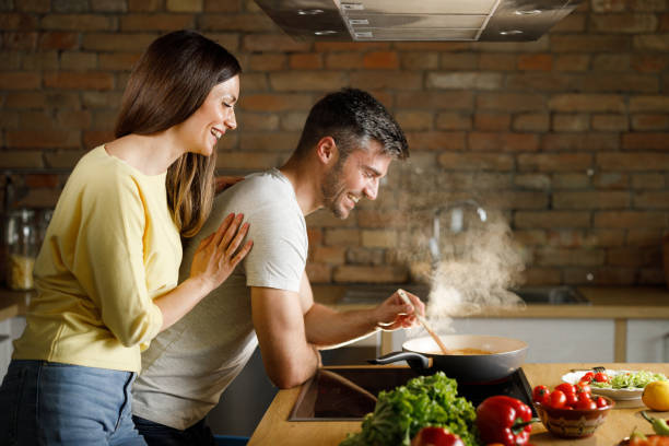 istock Happy couple cooking lunch in the kitchen. 1324650097