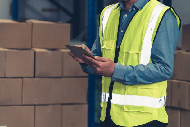 istock Asian warehouse worker checking packages in storehouse 1324650309