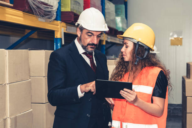 istock Warehouse senior manager discuss with worker in the storehouse 1324652097