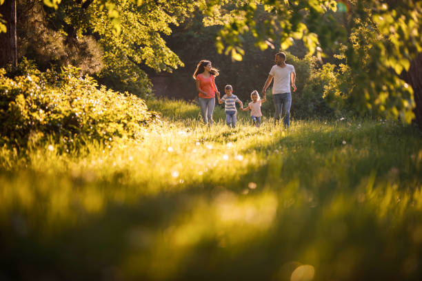 istock Happy family having fun while running in the forest. 1324653251