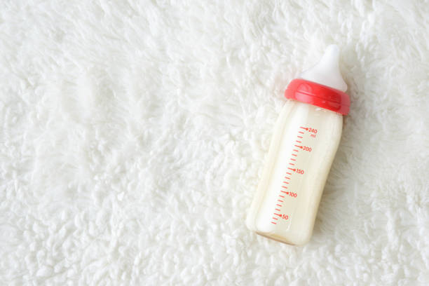 Baby bottle with formula on soft carpet