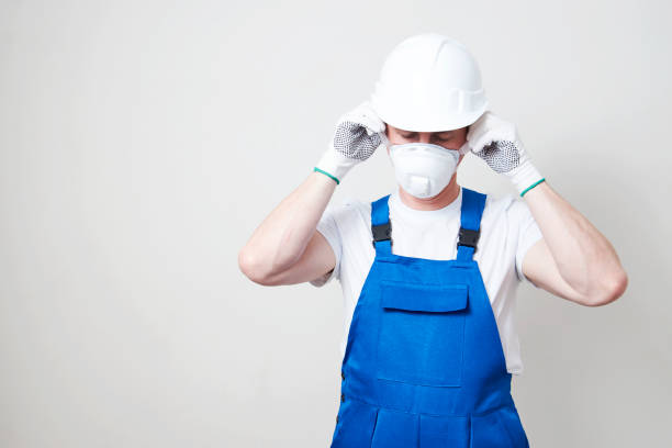istock Worker man wearing face mask and protective hard hat 1324654167