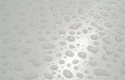 Closeup of water droplets texture on the acrylic tabletop after the rain