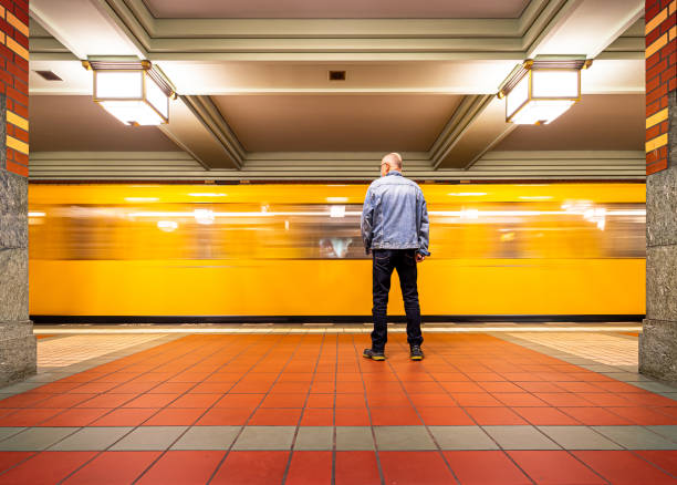 istock Rear View Of Man Standing At Subway Station 1324656295