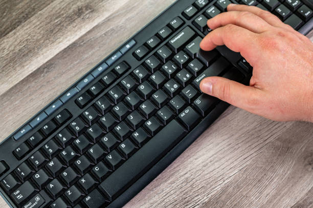 istock hands of a man typing on the pc keyboard 1324660403