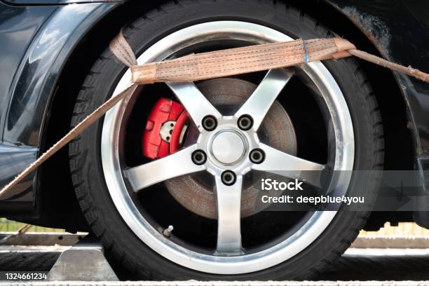 Belt Hook On The Tire Of The Towed Car Stock Photo - Download Image Now - Tow Truck, Towing, Strap