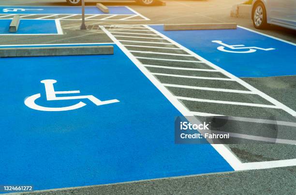 Asphalt Car Parking Lot Reserved For Handicapped Driver In Supermarket Or Shopping Mall Car Parking Space For Disabled People Wheelchair Sign Paint On Asphalt Parking Area Handicapped Parking Lot Stock Photo - Download Image Now