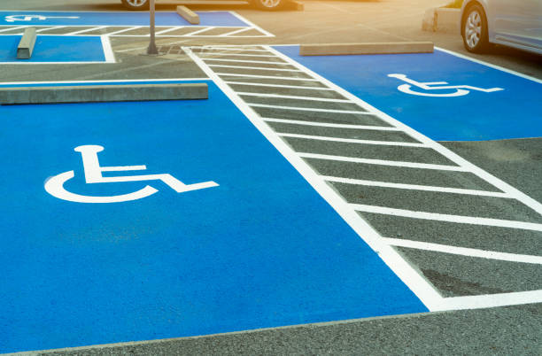 asphalt car parking lot reserved for handicapped driver in supermarket or shopping mall. car parking space for disabled people. wheelchair sign paint on asphalt parking area. handicapped parking lot. - physical impairment wheelchair disabled accessibility imagens e fotografias de stock