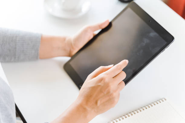 istock Close up of young women using digital tablet for working in the office. 1324663396