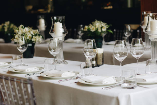istock tableware Glasses, flower fork, knife served for dinner in restaurant with cozy interior 1324665902