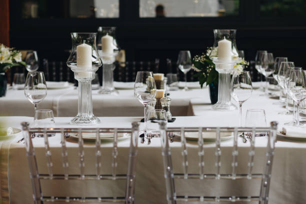 istock tableware Glasses, flower fork, knife served for dinner in restaurant with cozy interior 1324666159