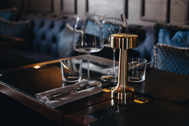 istock tableware Glasses, flower fork, knife served for dinner in restaurant with cozy interior 1324666411