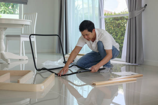 istock Asian man assembling furniture at home 1324666435