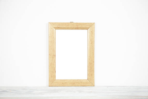 istock Vintage wooden frame on a table against a white wall 1324667704