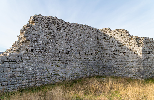 Podgorica, Municipality of Podgorica Capital City, Montenegro - February 29, 2020: Stone wall on field against clear sky.