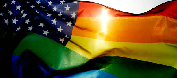 istock rainbow US flag waving on the sky, web banner 1324670572