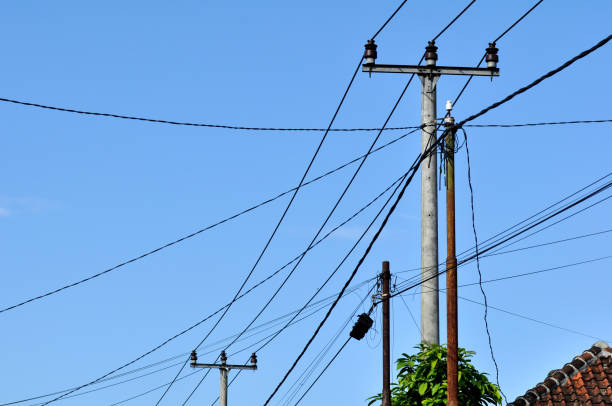 istock Electric cables and poles in residential areas of West Java, Indonesia 1324670609
