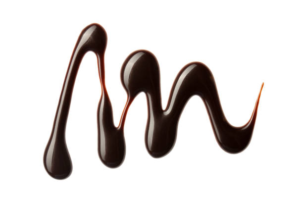 istock Chocolate sauce swirl isolated on whited background. Hot melted chocolate. Liquid Choco. Decorative line 1324670697