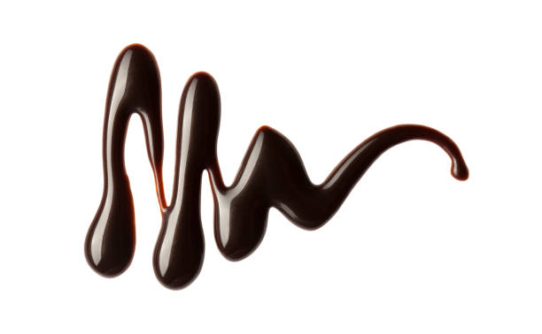 istock Chocolate sauce swirl isolated on whited background. Hot melted chocolate. Liquid Choco. Decorative line 1324670705