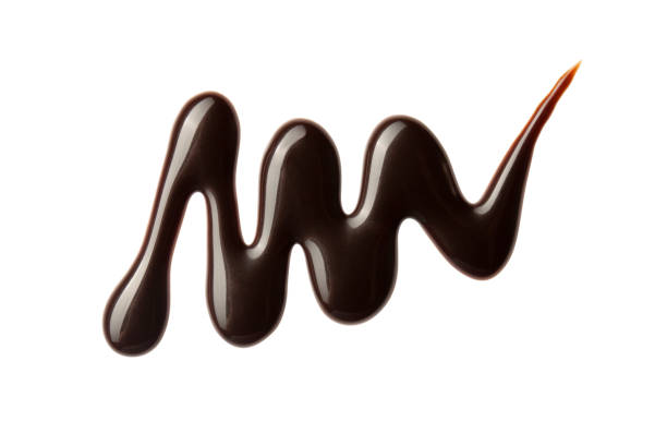 istock Chocolate sauce swirl isolated on whited background. Hot melted chocolate. Liquid Choco. Decorative line 1324670724