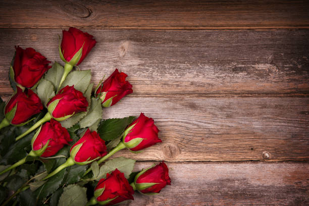 istock Red roses on old wood 1324672782