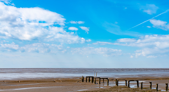 Old pier and mudflats at Snettisham, Norfolk. This is on the The Wash and has miles of mudflats at low tide.