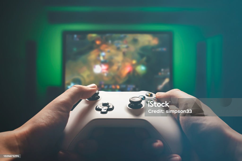 Video gaming console. Man playing RPG strategy game Man is playing on the console. Man holding gamepad and playing RPG Video Game Stock Photo