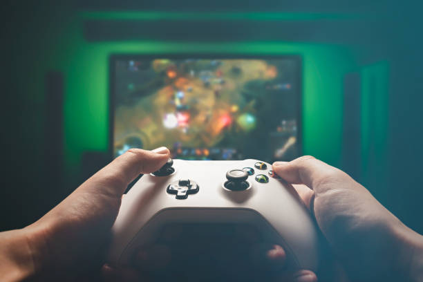 Video gaming console. Man playing RPG strategy game Man is playing on the console. Man holding gamepad and playing RPG games console stock pictures, royalty-free photos & images