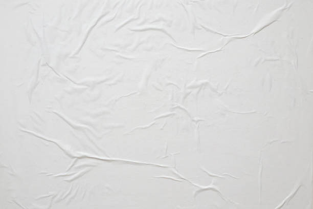 istock Blank white crumpled and creased paper poster texture background 1324673503