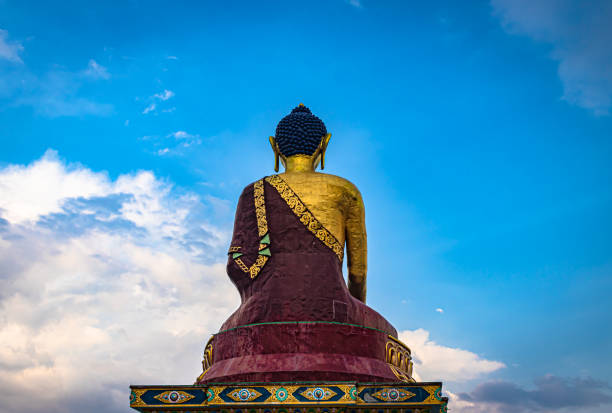 istock huge buddha golden statue from different perspective with bright blue sky at evening 1324677543