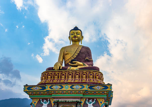 istock huge buddha golden statue from different perspective with bright blue sky at evening 1324677670
